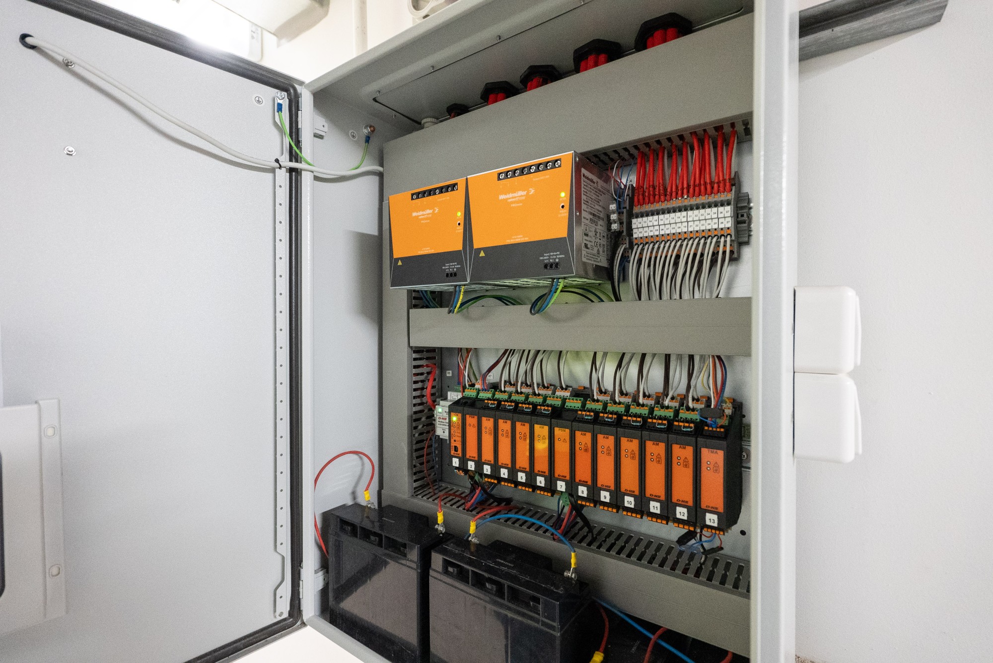 Internal view of the EBSA CPS-M control panel at Marvel Stadium with power supplies, control modules, terminal wiring and batteries
