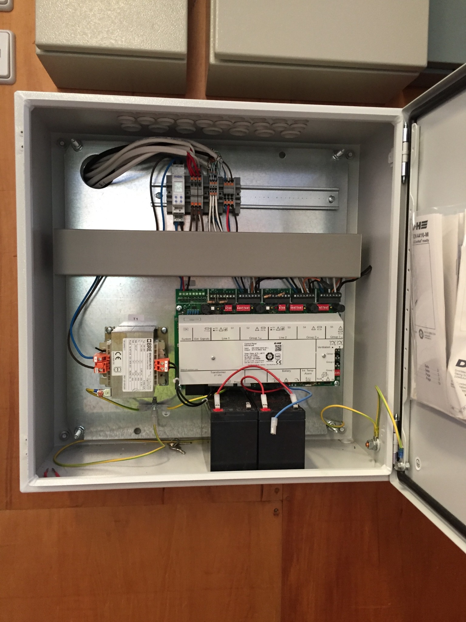 Open D+H RZN 4416-M control panel showing transformer, control board, batteries and field wiring ready for commissioning