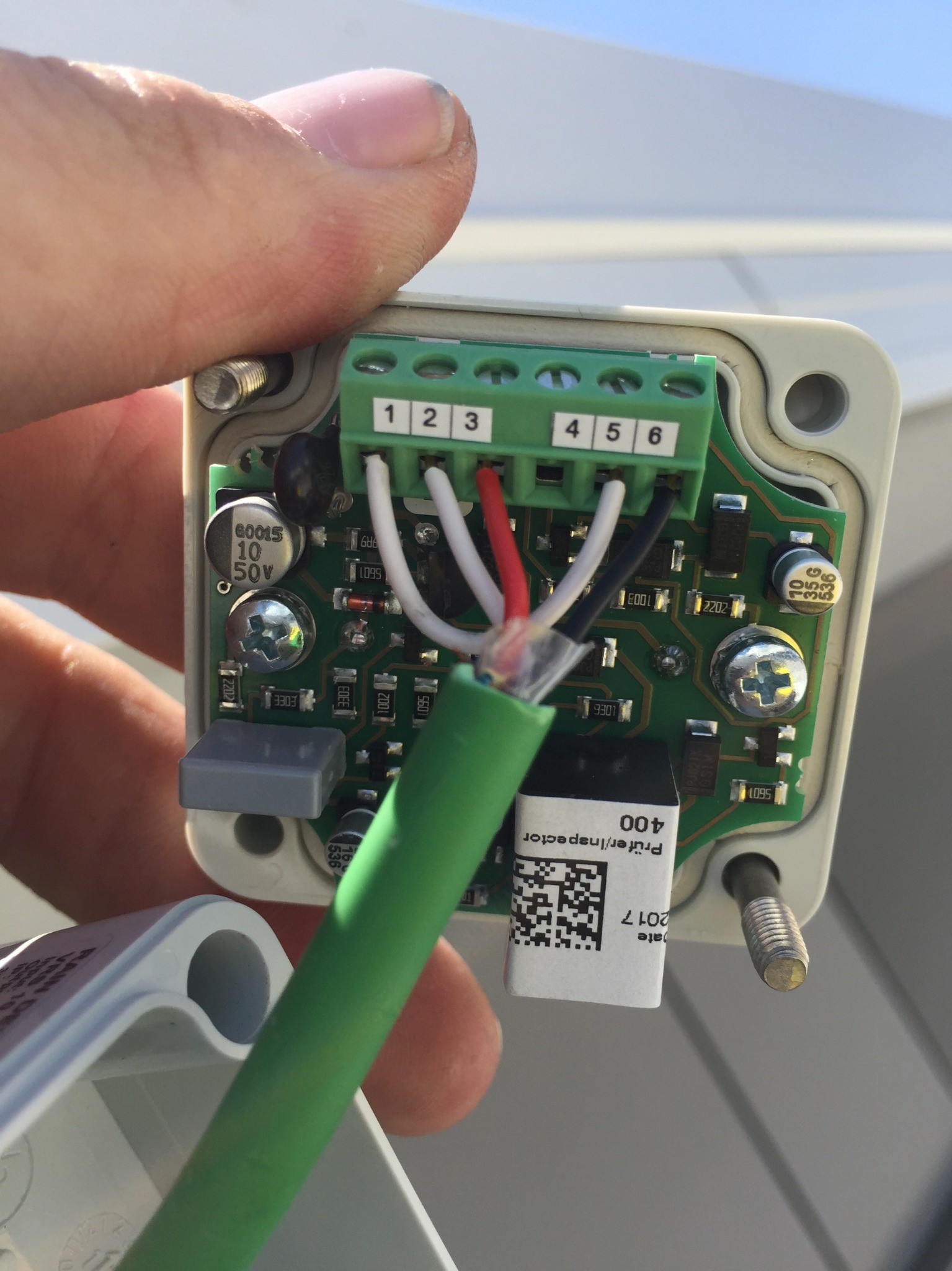 Close view of field wiring being connected to a D+H VRS10 rain sensor